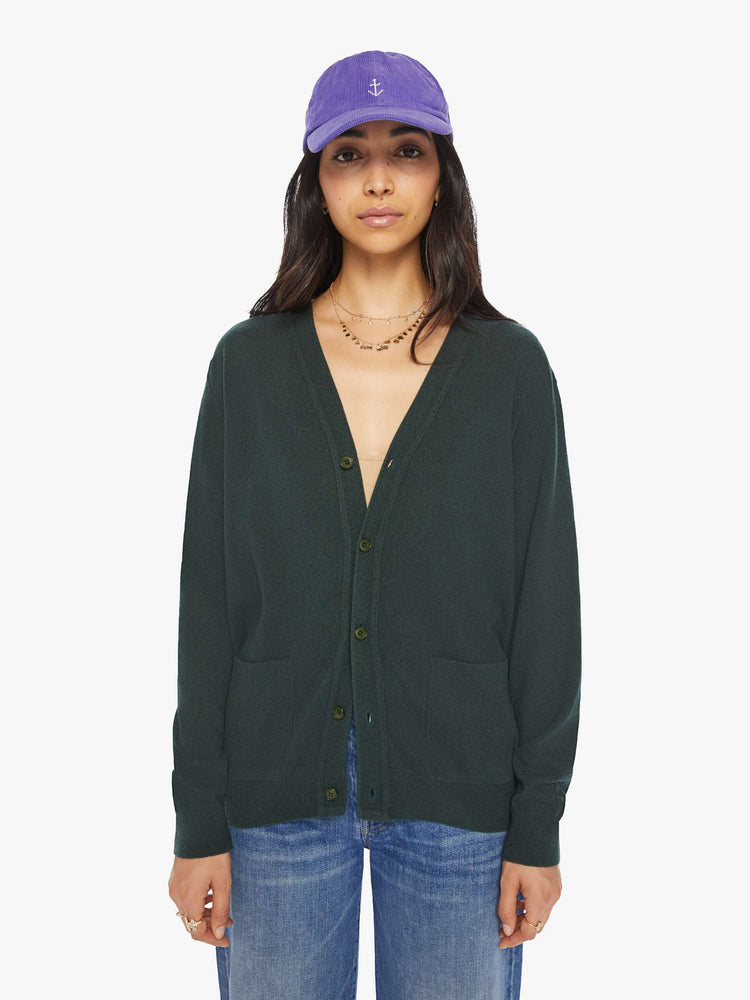 WOMEN front view of knit cardigan in a dark green hue with a V-neck, patch pockets and buttons down the front. 