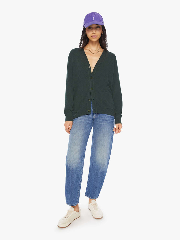 WOMEN full body view of knit cardigan in a dark green hue with a V-neck, patch pockets and buttons down the front.