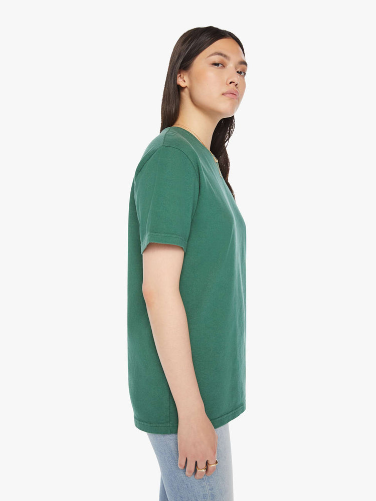 Side view of a woman green tee with a white anchor on the chest, has a ribbed crewneck and a straight fit.