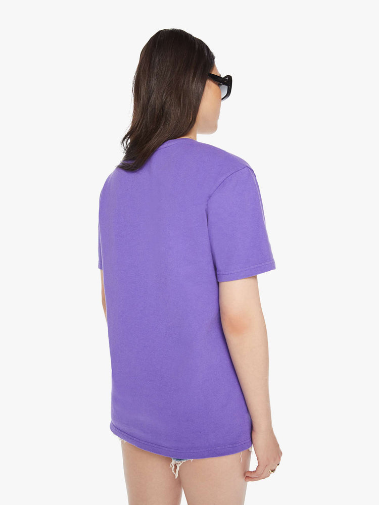 Back view of a woman purple tee with a white anchor on the chest, has a ribbed crewneck and a straight fit.