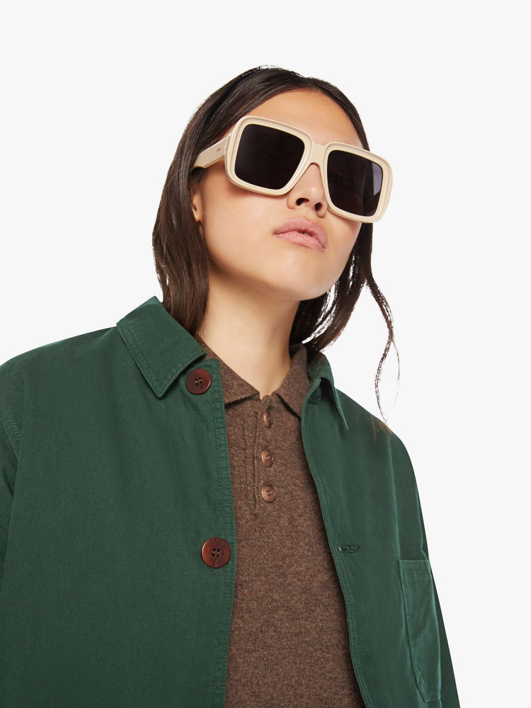 WOMEN close up view of a jacket in hunter green hue with front patch pockets, long sleeves, buttons down the front and a boxy fit.