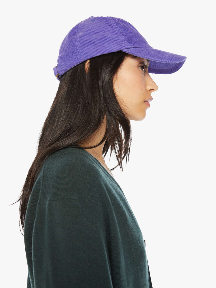 WOMEN side view of a woman purple hue corduroy hat with a white anchor on the front.