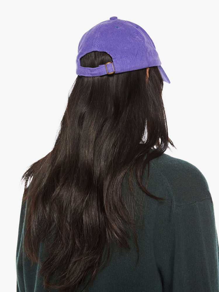 WOMEN back view of a woman purple hue corduroy hat with a white anchor on the front.