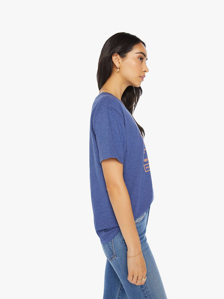 Side view of a woman classic crewneck with a slightly boxy shape, in navy blue, the tee features an orange Texas Two Step graphic.