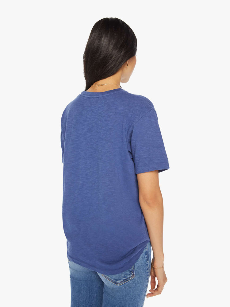 Back view of a woman classic crewneck with a slightly boxy shape, in navy blue, the tee features an orange Texas Two Step graphic.