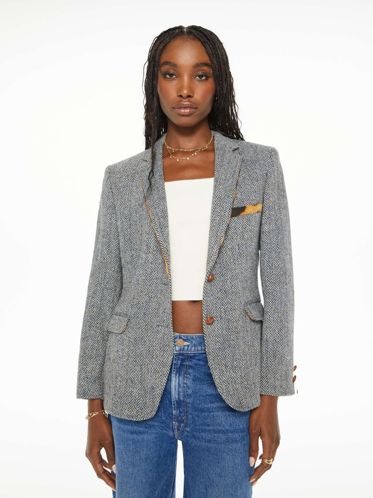 Front view of a woman vintage tweed jacket is made from 100% wool and is detailed with a leopard-lined collar and trim for a touch of color and warmth.