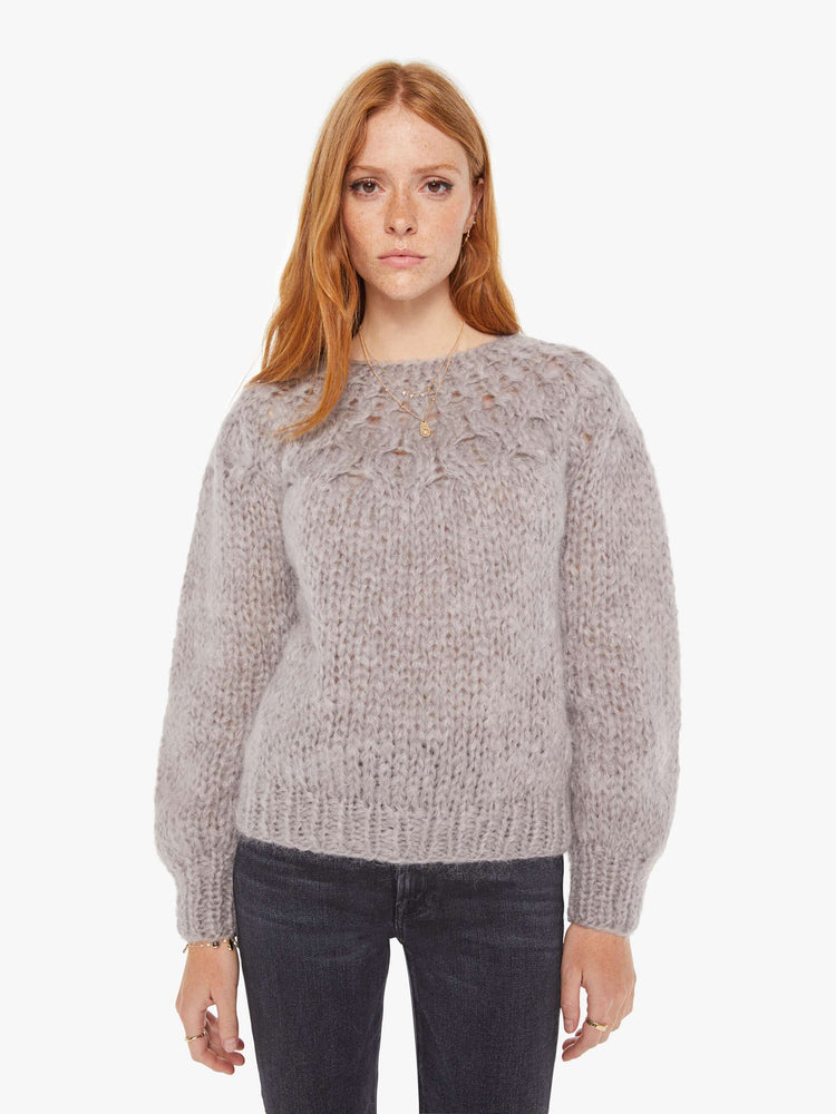 Front view of a womens chunky knit sweater in a grey hue featuring balloon sleeves and ribbed hems.