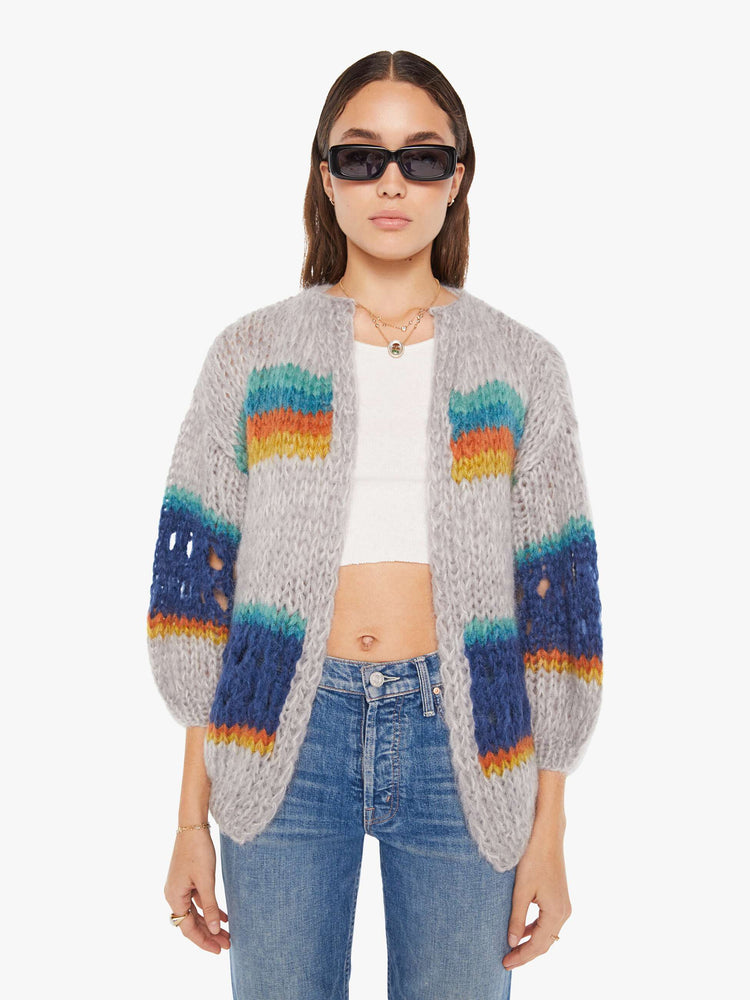 Front view of a womens chunky knit cardigan in multi color stripes, featuring a cropped body with balloon sleeves.