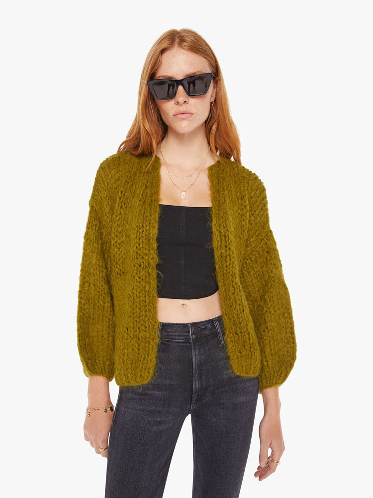 Front view of a womens chunky knit cardigan in a khaki hue featuring billow sleeves.