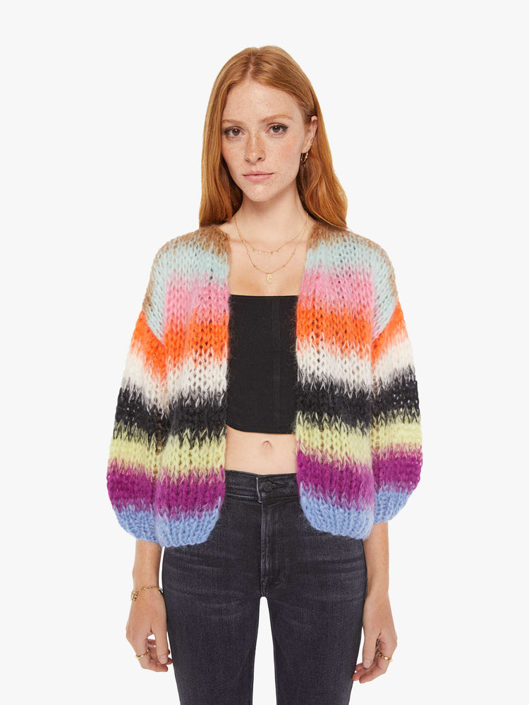 Front view of a womens chunky knit cardigan in multi color stripes, featuring a cropped body with balloon sleeves.