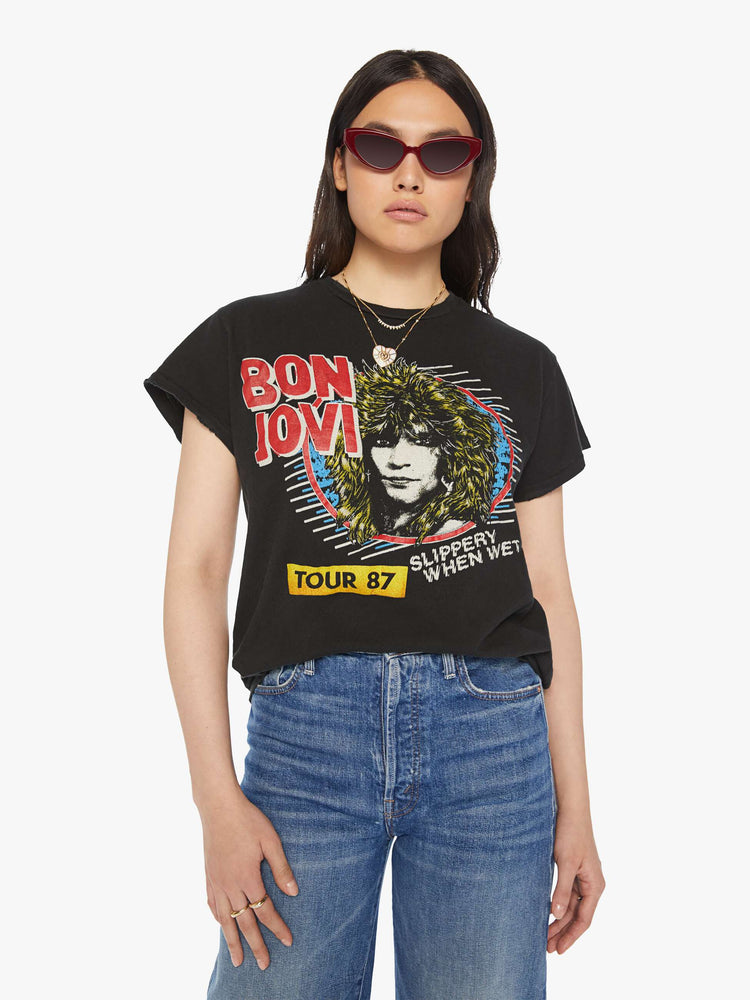 Front view of a woman distressed crewneck tee in black, the tee pays homage Bon Jovi with bold text and graphic portrait on the front.