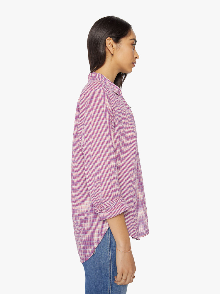Side view of a woman coral-pink button down.