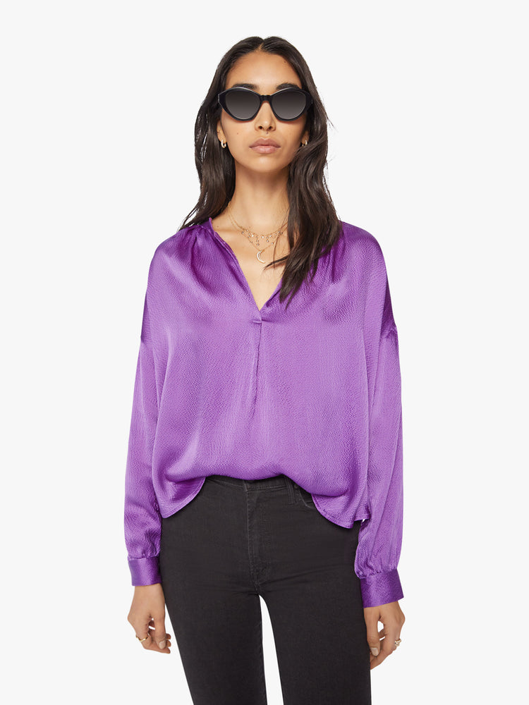 Front view of a woman longsleeve blouse in a  silk purple topaz hue designed with a V-neck, drop shoulders and a flowy fit.
