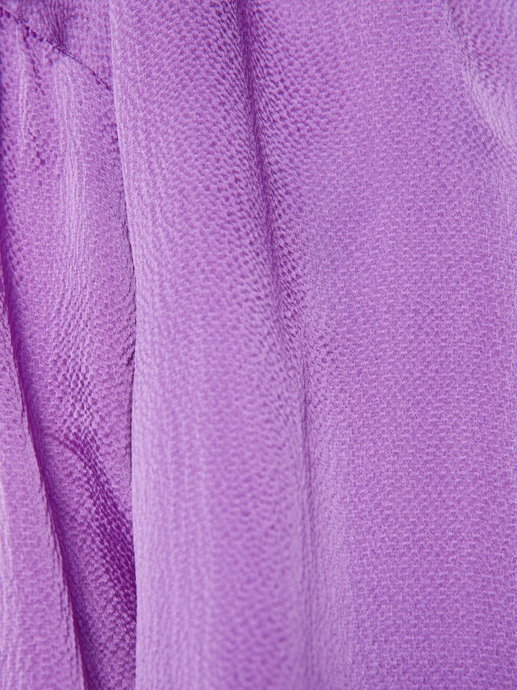Swatch view of a woman longsleeve blouse in a silk purple topaz hue designed with a V-neck, drop shoulders and a flowy fit.