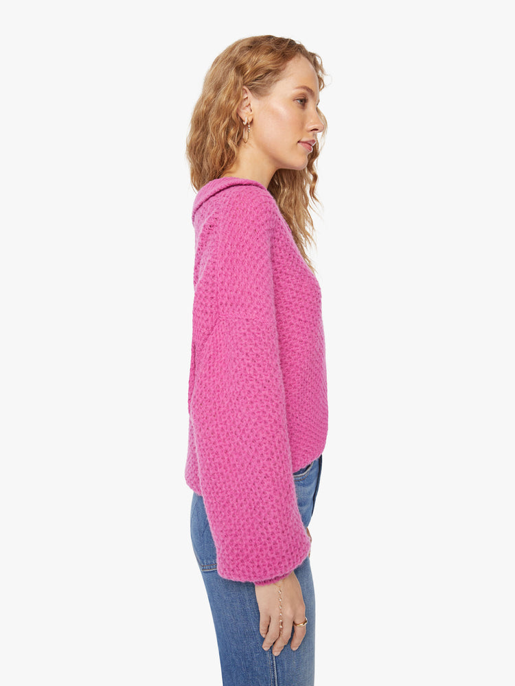 Side  view of a woman's oversized collar, V-neck, long balloon sleeves and a loose fit in a hot pink hue.