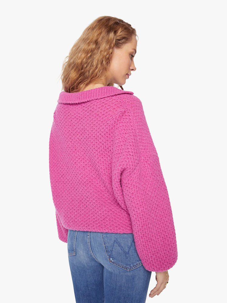 Back view of a woman's oversized collar, V-neck, long balloon sleeves and a loose fit in a hot pink hue.