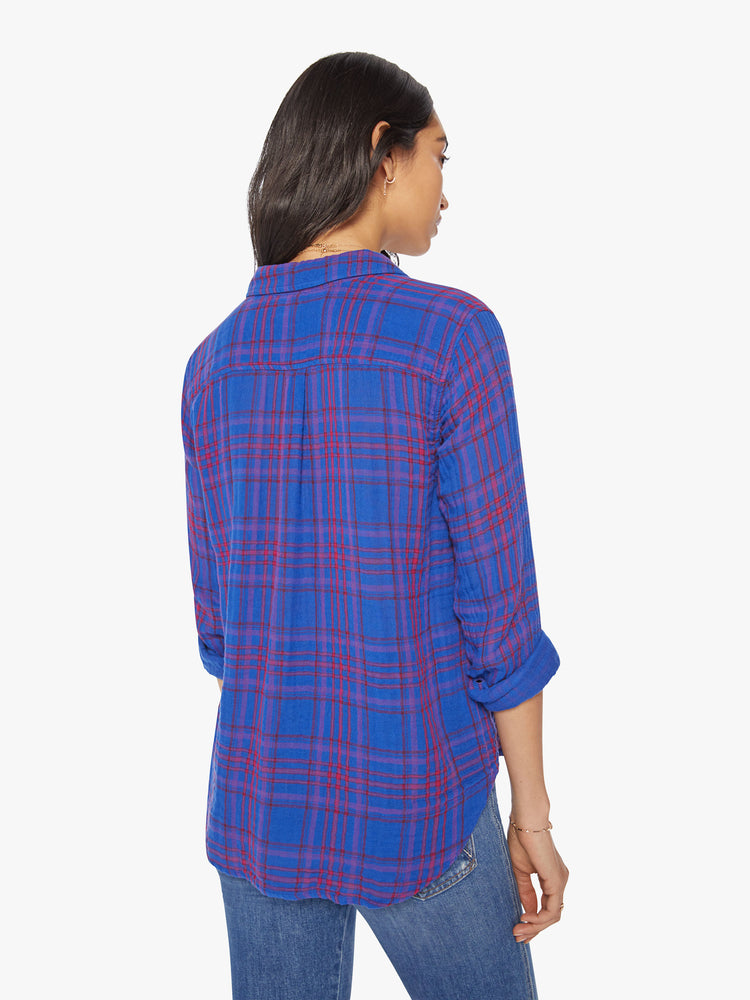 Back view of a women blue plaid button-down long-sleeve shirt features a V-neck and curved hem with a light and airy fit.