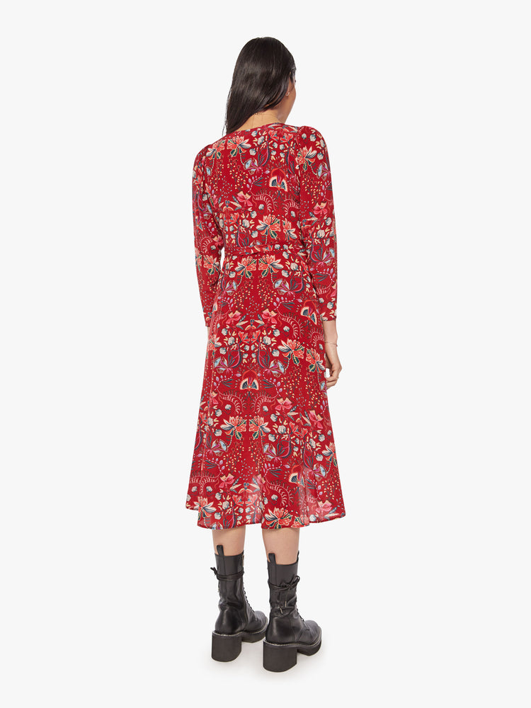 Back view of a woman red silk wrap midi dress with a V-neck, cropped long sleeves, and a wrapped design that ties at the waist.