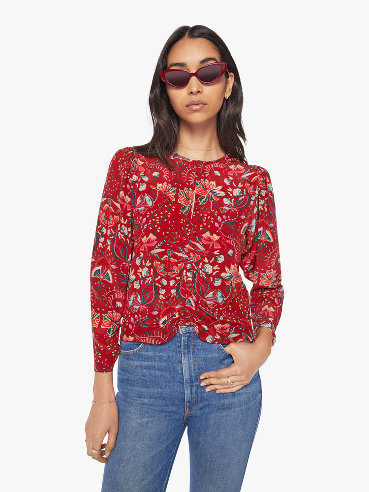 Front view of a woman 100% silk long-sleeve blouse with a crewneck, cropped long sleeves and a hip-grazing hem.