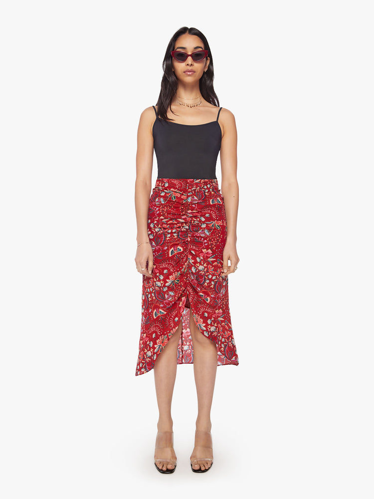 Front view of a woman 100% silk midi skirt with a high rise, gathered seam down the front and a calf-length hem in a floral print.