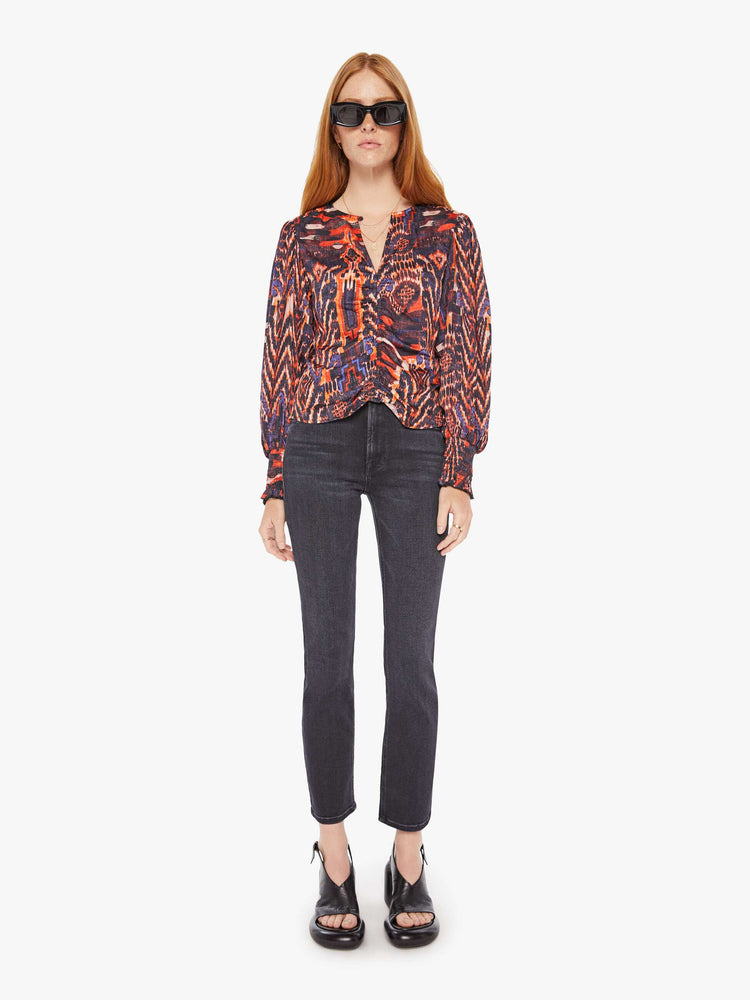 Front full body view of a womens blouse with a vibrant multi color print and balloon sleeves. 
