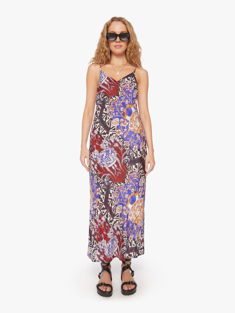 Front view of a woman slip dress in bold prints and modern neutrals, with a V-neck, thin straps, an ankle-length hem and a flowy fit.