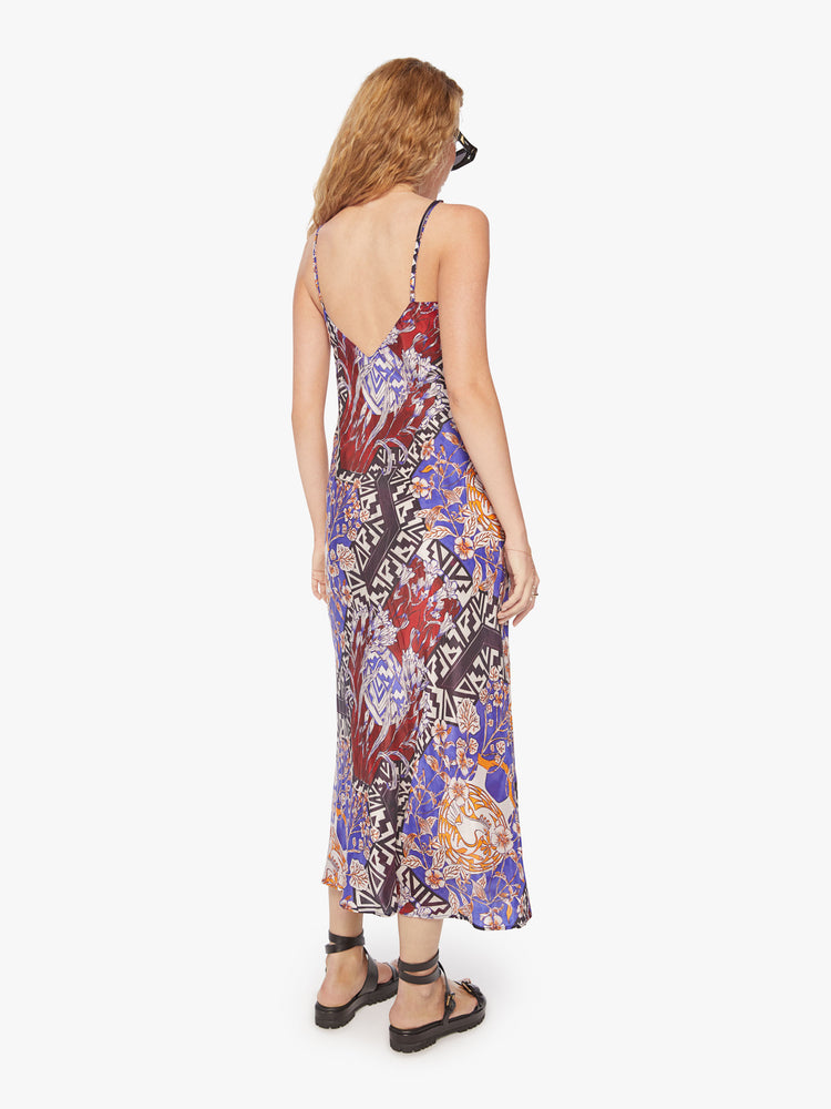Back view of a woman slip dress in bold prints and modern neutrals, with a V-neck, thin straps, an ankle-length hem and a flowy fit.