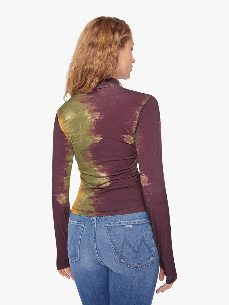 Back view of a woman long sleeve turtleneck in bold prints and modern neutrals, with a gathered seam down the front, thumbholes and a narrow fit.
