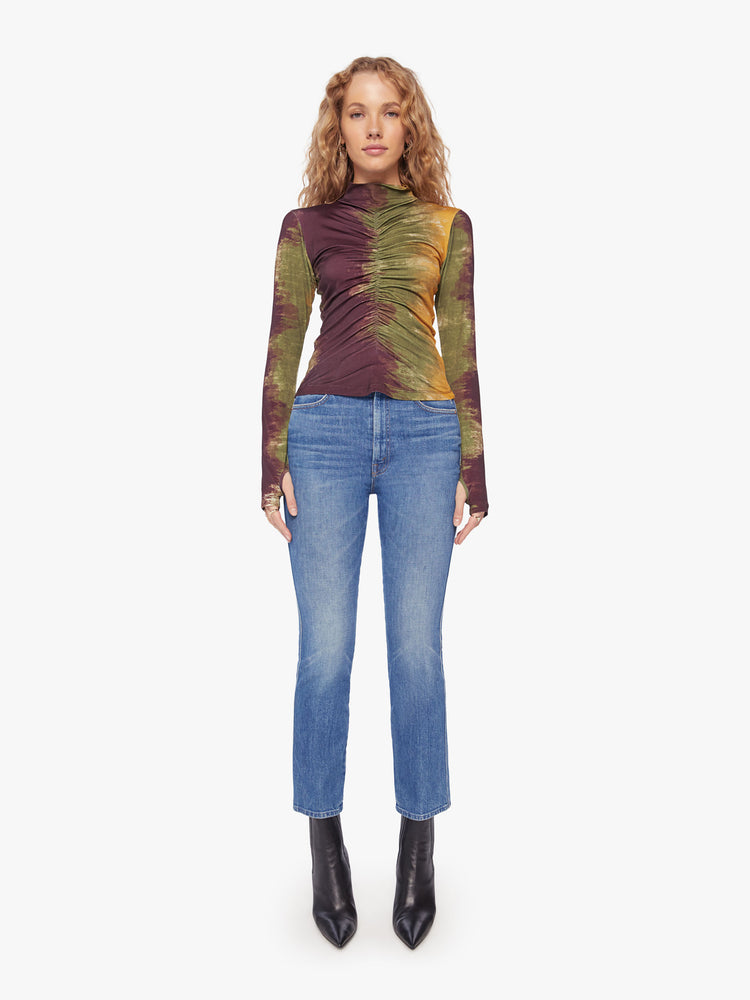 Full body view of a woman long sleeve turtleneck in bold prints and modern neutrals, with a gathered seam down the front, thumbholes and a narrow fit.