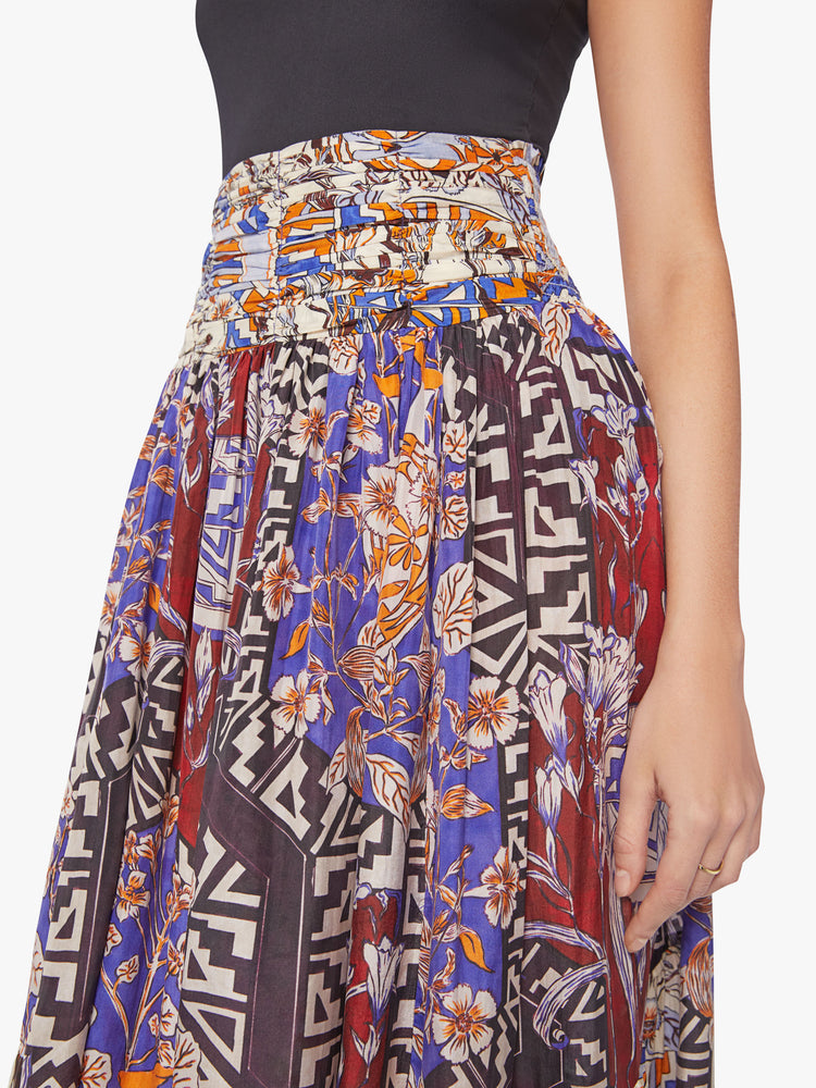 Close up view of a woman maxi skirt in bold prints and modern neutrals, with a super high rise, tiered skirt, uneven hem and a flowy fit.