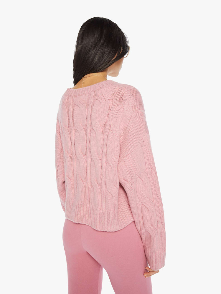 Back view of a woman pink knit sweater with crew neck, drop shoulders, extra-long sleeves and a loose fit.