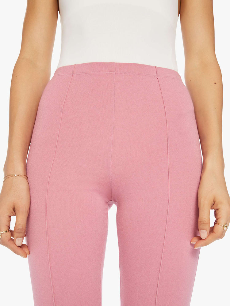 Close up view of woman pink flared legging with a high rise, flared leg, long inseam and a pintuck detail down the front of each leg.