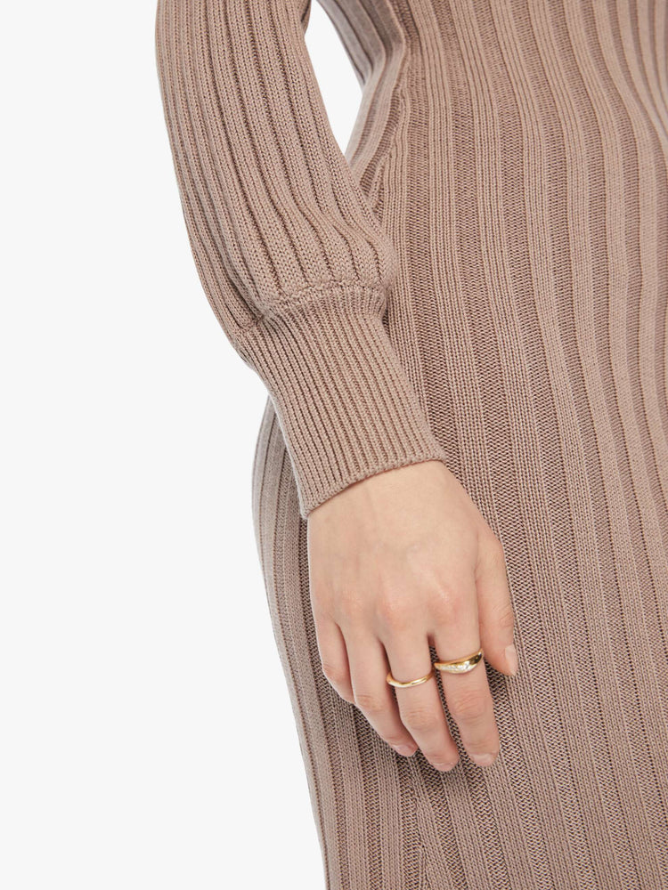 Arm hem view of a woman toast colored hue dress with a crewneck, long balloon sleeves that are fitted at the wrists, and a hem that hits just below the knee.