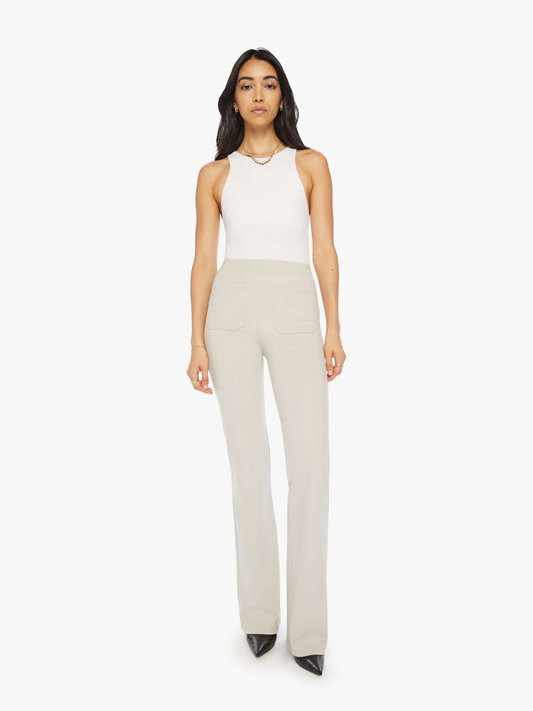 Front view of a woman off white trousers with a high rise, straight leg, long inseam and patch pockets.