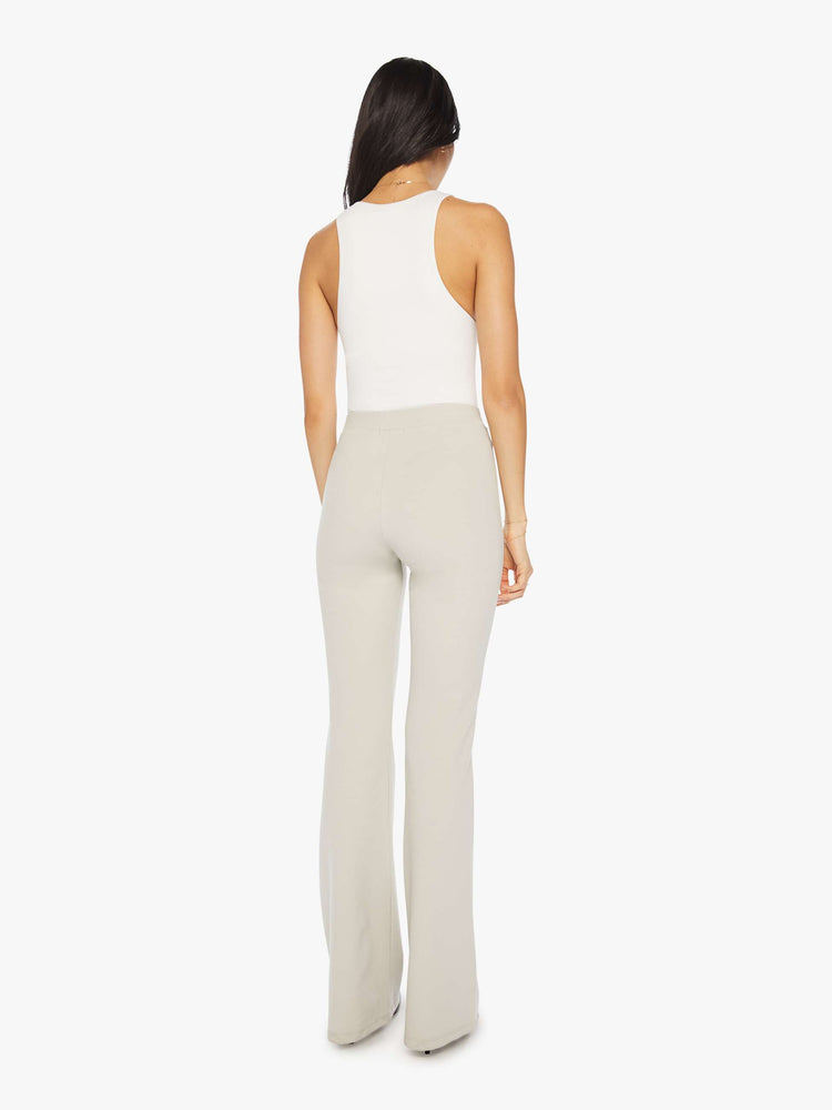 Back view of a woman off white trousers with a high rise, straight leg, long inseam and patch pockets.
