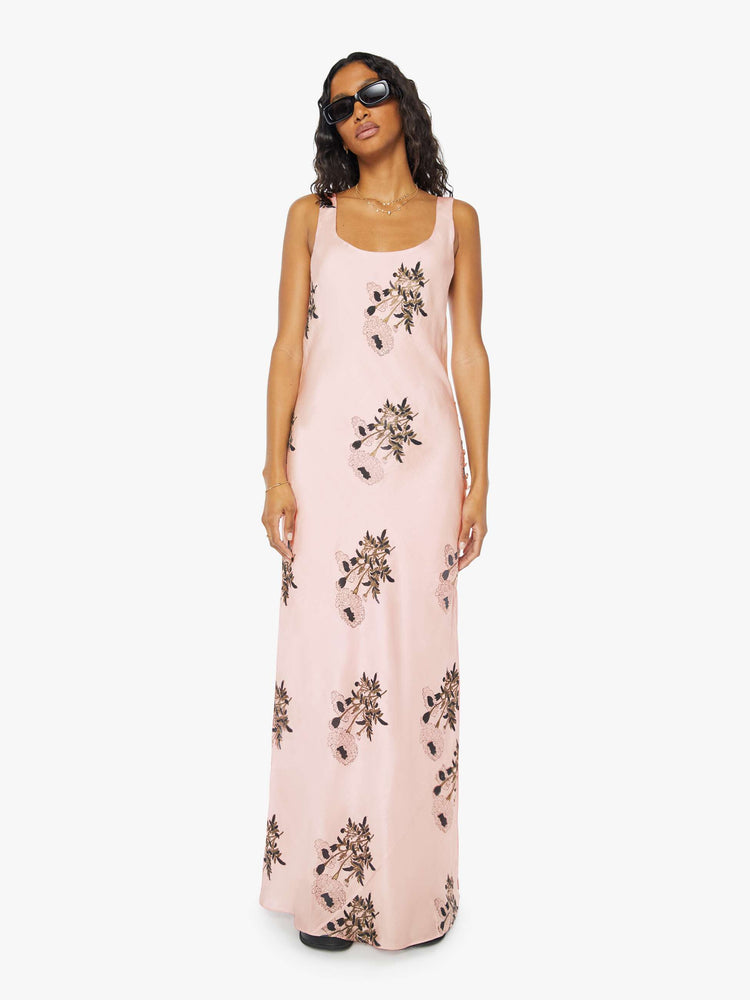 Front view of a womens pink silk dress featuring a floral print and ankle length hem..