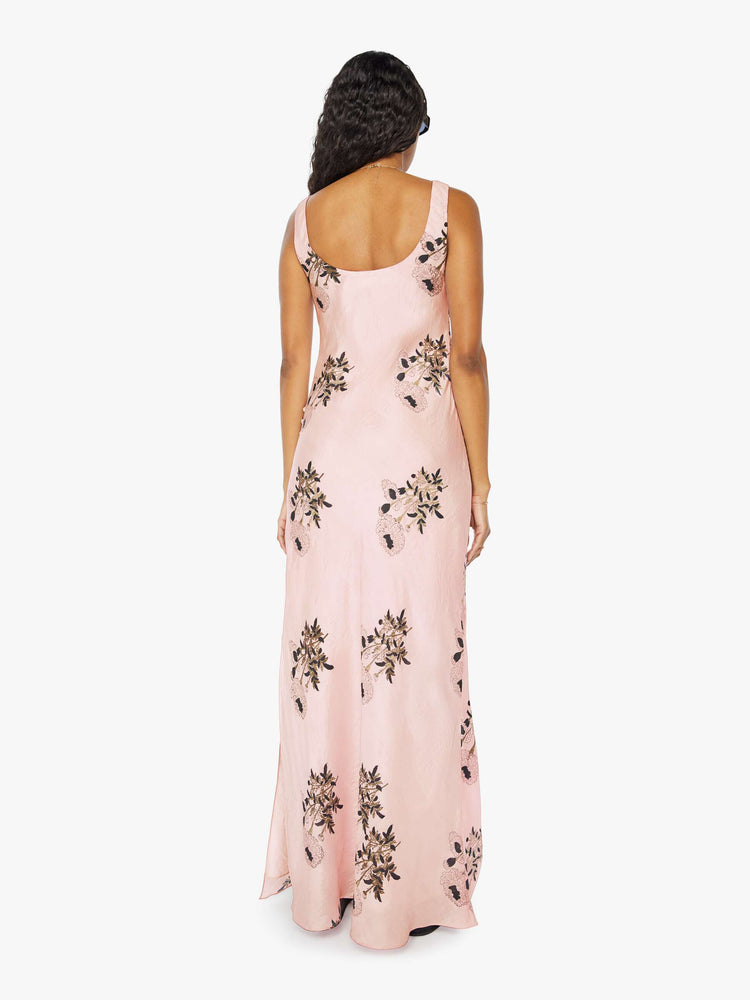 Back view of a womens pink silk dress featuring a floral print and ankle length hem..