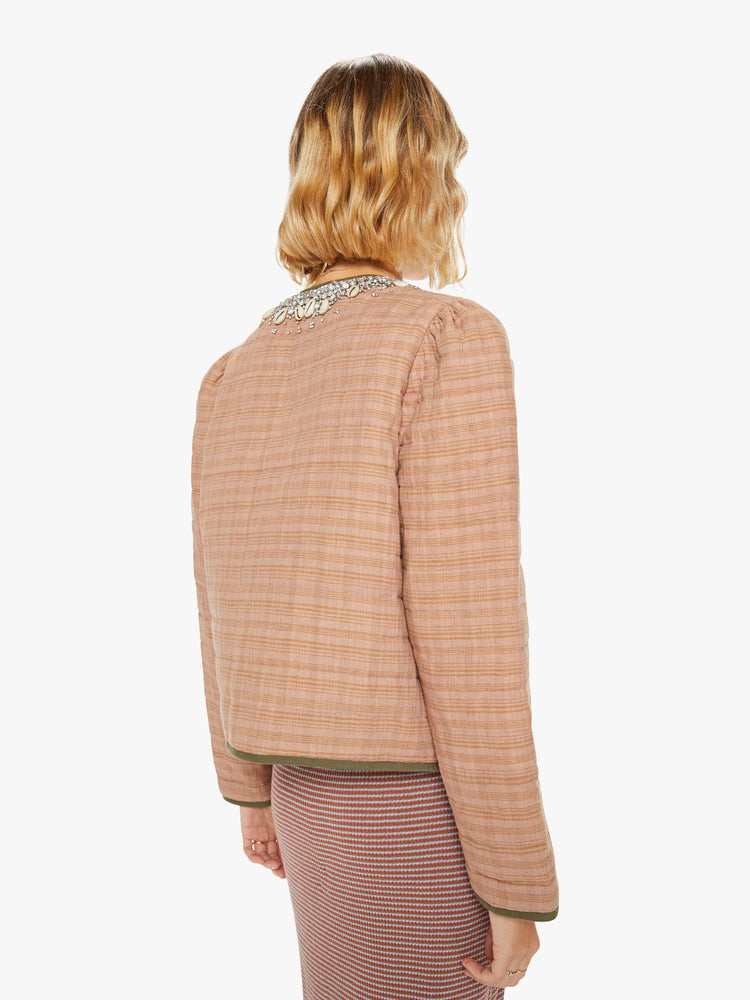 Back view of a woman jacket in a pink stripe pattern with dark green trim and shell and gem applique at the collar and pockets with a V-neck, tie closure, puffed sleeves and a boxy fit.