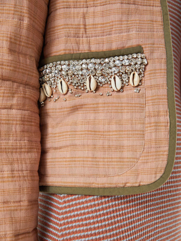 Swatch view of a woman jacket in a pink stripe pattern with dark green trim and shell and gem applique at the collar and pockets with a V-neck, tie closure, puffed sleeves and a boxy fit.