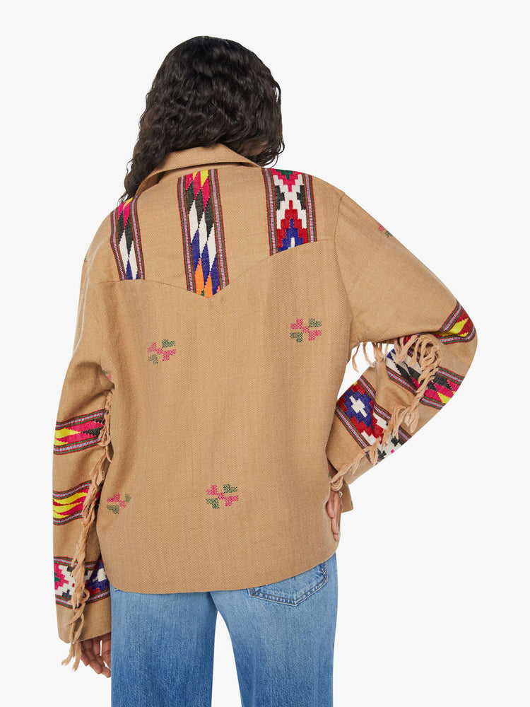 Back view of a woman Western blanket patchwork and fringe details Jacket, and features a notched collar, drop shoulders, patch pockets and a tie closure.