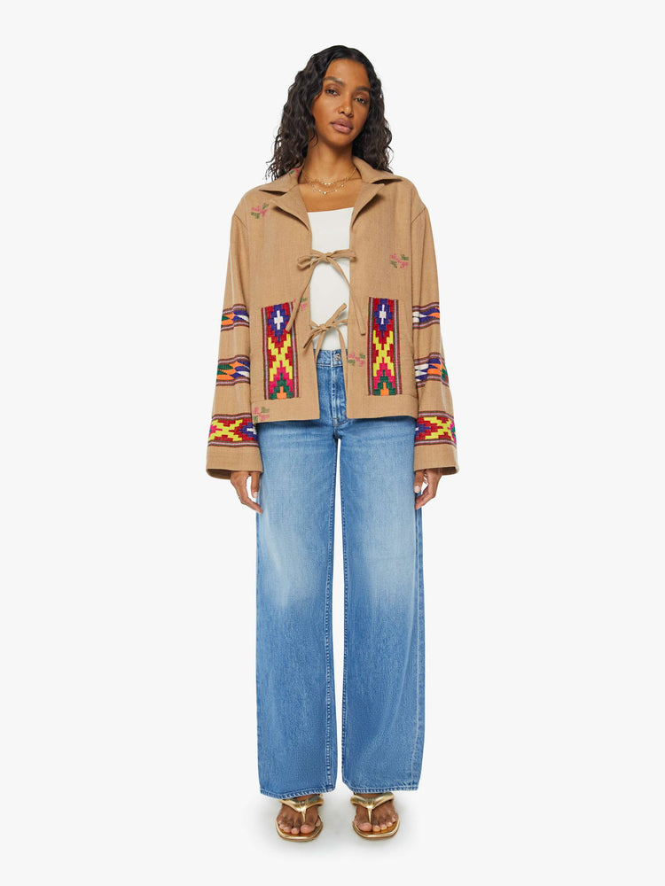 Full body view of a woman Western blanket patchwork and fringe details Jacket, and features a notched collar, drop shoulders, patch pockets and a tie closure.