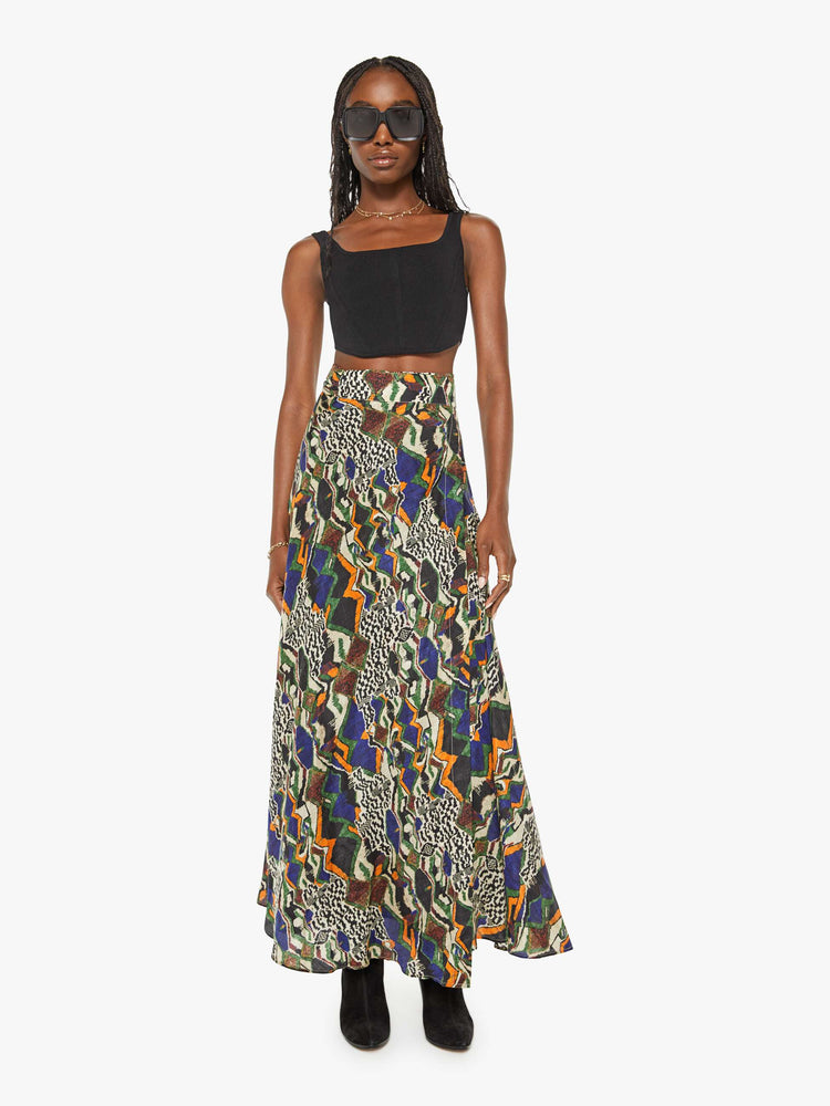 Front view of a woman bold prints and modern neutrals maxi skirt with a super high rise, thick waistband and a loose, flowy fit with an ankle-length hem.