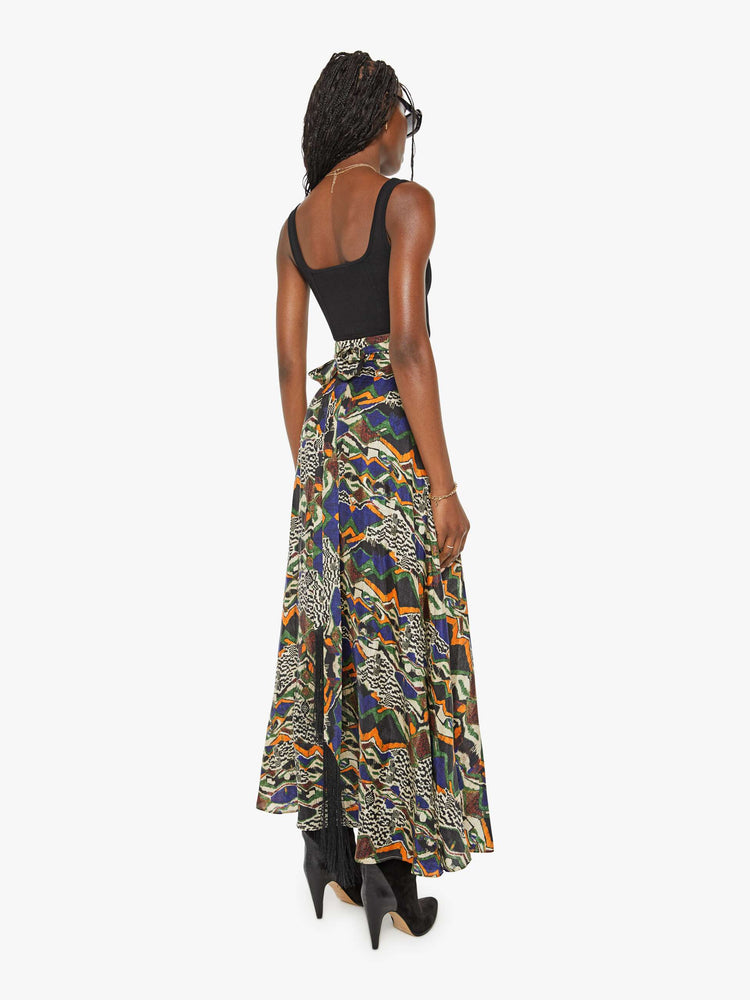 Back view of a woman bold prints and modern neutrals maxi skirt with a super high rise, thick waistband and a loose, flowy fit with an ankle-length hem.