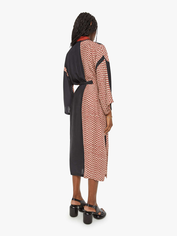 Back view of a woman robe with colorblocked silk in black and a red-and-white zig zag print, and features drop shoulders, a calf-length hem and a loose, flowy fit.