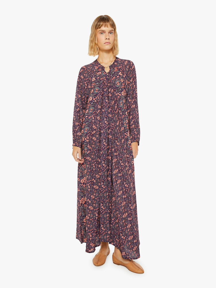 Front view of a woman purple and pink floral print maxi dress with voluminous sleeves and has an A-line cut for a loose, breezy feel.