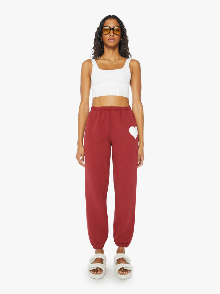Front view of a woman crimson red sweatpants with an elastic waist and cuffs for a loose, comfortable fit.