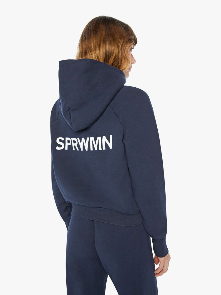 Back view of a woman navy cozy raglan hoodie with the brand's logo in white on the back.