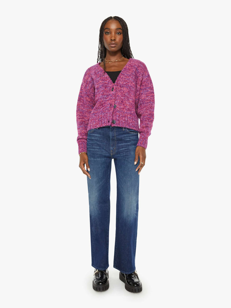 Full body view of a woman magenta hue sweater with a V-neck, long sleeves, ribbed hems and buttons down the front.