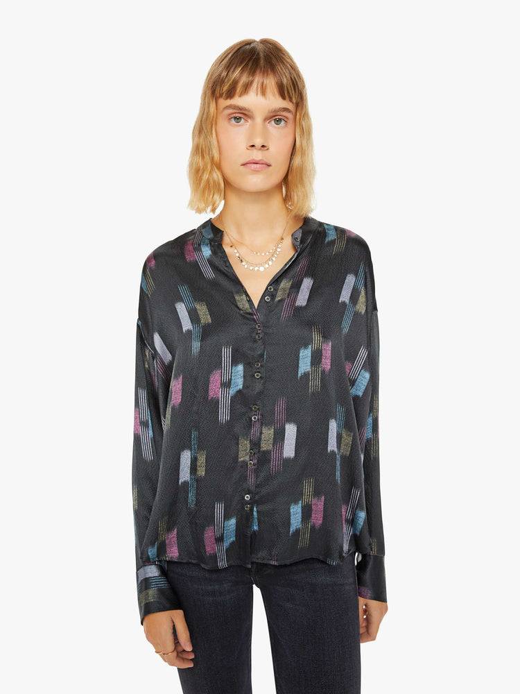 Front view of a woman black shirt with a cool toned graphic print with drop shoulders, long balloon sleeves, a slightly curved hem and buttons down the front.