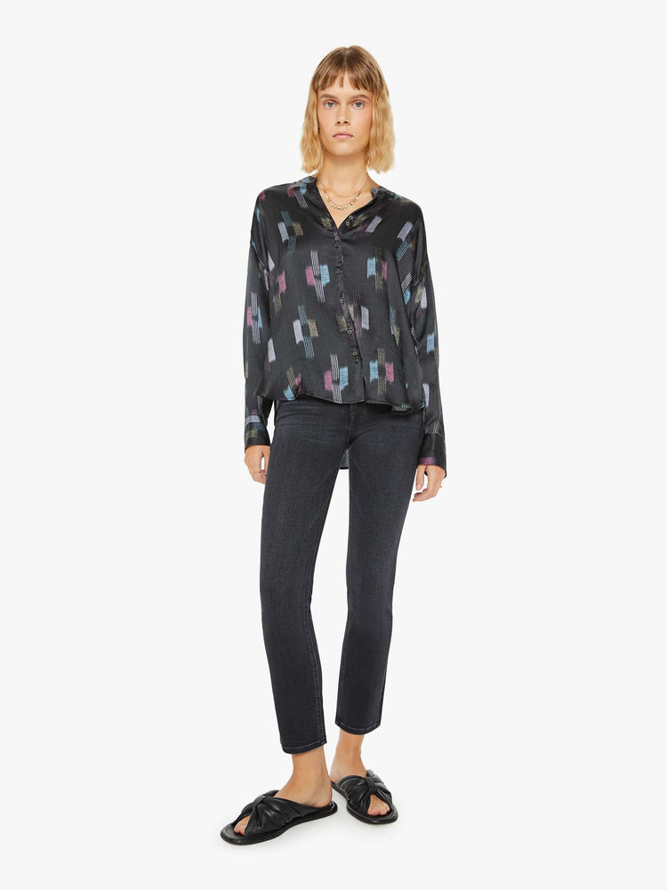 Full body view of a woman black shirt with a cool toned graphic print with drop shoulders, long balloon sleeves, a slightly curved hem and buttons down the front.